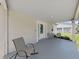 Neutral painted porch with outdoor seating, ideal for enjoying quiet moments and neighborhood views at 9413 Forest Hills Dr, Tampa, FL 33612