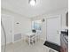 Eat-in kitchen with a white table and seating, dark cabinetry, and access to the backyard at 9413 Forest Hills Dr, Tampa, FL 33612
