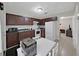 Efficient kitchen featuring dark cabinets, essential appliances, and a white table for casual dining at 9413 Forest Hills Dr, Tampa, FL 33612
