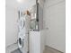 A bright laundry room features a white washer and dryer and the home's HVAC system at 9413 Forest Hills Dr, Tampa, FL 33612