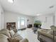 Neutral living room showcasing tile flooring, comfortable furniture, and access to the home's entrance at 9413 Forest Hills Dr, Tampa, FL 33612