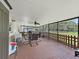 The screened-in patio features wood flooring and a ceiling fan, overlooking the backyard at 9413 Forest Hills Dr, Tampa, FL 33612
