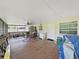 The screened-in patio features wood flooring and a ceiling fan, with access to the backyard at 9413 Forest Hills Dr, Tampa, FL 33612