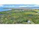 Majestic aerial view of a waterfront, coastal area with a home nestled in lush greenery at 950 Waverly St, Oldsmar, FL 34677