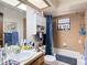 Modest bathroom with a shower-tub combo and blue accents, including a matching shower curtain at 950 Waverly St, Oldsmar, FL 34677