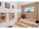 Well-lit bathroom with a built-in bathtub, neutral tile, and decorative towel racks at 950 Waverly St, Oldsmar, FL 34677