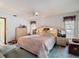 Spacious bedroom features comfortable bedding, light fixtures, and ample closet space at 950 Waverly St, Oldsmar, FL 34677