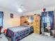 Cozy bedroom featuring a ceiling fan, wardrobe, and a patterned bedspread with character at 950 Waverly St, Oldsmar, FL 34677