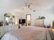 Bright bedroom with a ceiling fan and traditional decor including a large bed and matching dressers at 950 Waverly St, Oldsmar, FL 34677