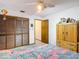 Bedroom with closet, ceiling fan, and unique patterned bedding, offering a cozy atmosphere at 950 Waverly St, Oldsmar, FL 34677