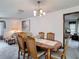 Cozy dining room next to the living room with chandelier lighting and views of the patio at 950 Waverly St, Oldsmar, FL 34677