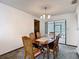 An inviting dining room with a classic wooden table set and sliding glass doors to a screened patio at 950 Waverly St, Oldsmar, FL 34677