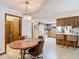 Dining room adjacent to kitchen; vintage table seats four with wood paneled accent wall, seamlessly blending style and comfort at 950 Waverly St, Oldsmar, FL 34677