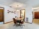 Dining room with vintage table, comfortably seating four, adjacent to laundry room and access to the main bedroom at 950 Waverly St, Oldsmar, FL 34677