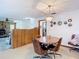 Dining room with a vintage table, seating four with wood paneled accent wall, seamlessly blending style and comfort at 950 Waverly St, Oldsmar, FL 34677