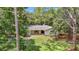 A quaint single-story home nestled among mature trees with a well-kept lawn and stone pillar accents at 950 Waverly St, Oldsmar, FL 34677