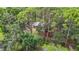 Exterior shows the property nestled among mature trees, offering privacy and a natural setting at 950 Waverly St, Oldsmar, FL 34677
