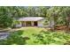 Charming single-story home with stone accents and a well-maintained lawn surrounded by mature trees at 950 Waverly St, Oldsmar, FL 34677