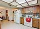 Spacious kitchen featuring wood cabinetry and white appliances, with ample storage and a bright, airy feel at 950 Waverly St, Oldsmar, FL 34677