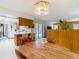 Open-concept kitchen featuring wood cabinets, and a breakfast bar, blending style and functionality seamlessly at 950 Waverly St, Oldsmar, FL 34677