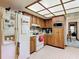 Bright kitchen showcasing white appliances and wood cabinets, complete with overhead lighting and ample counter space at 950 Waverly St, Oldsmar, FL 34677
