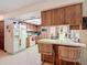 Kitchen view featuring wooden cabinets and a breakfast bar, seamlessly blending style and functionality at 950 Waverly St, Oldsmar, FL 34677