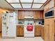 White appliances complement wood cabinets in this kitchen, with an eye-catching skylight that adds natural light at 950 Waverly St, Oldsmar, FL 34677