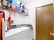 Functional laundry room with a washer, dryer, and storage shelves at 950 Waverly St, Oldsmar, FL 34677