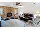 The living room features a stone fireplace, a brown leather sofa, and plenty of natural light at 950 Waverly St, Oldsmar, FL 34677