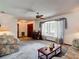 The comfortable living room features a bay window, ceiling fan, and a glimpse of the front doors at 950 Waverly St, Oldsmar, FL 34677