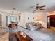 The living room flows into the dining area with natural light, floral sofas, and a ceiling fan at 950 Waverly St, Oldsmar, FL 34677