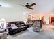 Spacious living room showcases a large brown leather sofa, ceiling fan, and bright natural light at 950 Waverly St, Oldsmar, FL 34677