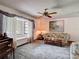 A bright living room with a bay window seating area, ceiling fan, and cozy floral pattern sofas at 950 Waverly St, Oldsmar, FL 34677