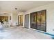 Covered back porch provides an outdoor living area with sliding glass doors and serene backyard views at 950 Waverly St, Oldsmar, FL 34677