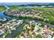 Stunning aerial view of the waterfront community with lush greenery and beautiful homes at 10732 Drummond Rd, Tampa, FL 33615