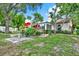 Spacious backyard with a well-maintained lawn, beautiful landscaping, and a charming back deck at 10732 Drummond Rd, Tampa, FL 33615