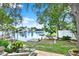 Backyard with a dock, scenic water views, and a well-manicured lawn, offering a serene outdoor space at 10732 Drummond Rd, Tampa, FL 33615