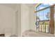 Bright bathroom with a large window, decorative glass, soaking tub, and a neutral color scheme at 10732 Drummond Rd, Tampa, FL 33615