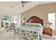 Bright bedroom featuring a floral quilt, bay window, and neutral walls, creating a cozy and inviting atmosphere at 10732 Drummond Rd, Tampa, FL 33615