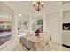 Bright breakfast nook with charming floral tablecloth and views of the sunroom at 10732 Drummond Rd, Tampa, FL 33615
