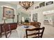 Dining room featuring an ornate chandelier, a fruit bowl centerpiece, and classic furnishings at 10732 Drummond Rd, Tampa, FL 33615