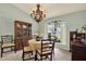 Bright dining room showcasing a chandelier, built-in cabinet, and a fruit bowl centerpiece at 10732 Drummond Rd, Tampa, FL 33615