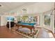 Entertaining space with pool table, lounge chairs, and views of the water at 10732 Drummond Rd, Tampa, FL 33615
