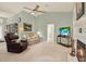 Cozy living room with a fireplace, comfortable seating, and ample space for relaxation and entertainment at 10732 Drummond Rd, Tampa, FL 33615