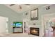 Bright living room featuring a fireplace, television, and an open layout, ideal for modern living at 10732 Drummond Rd, Tampa, FL 33615