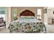 Main bedroom with a decorative headboard, floral bedding, and lots of natural light at 10732 Drummond Rd, Tampa, FL 33615
