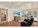 Inviting sun room with comfortable seating, a television, and large windows that let in lots of natural light at 10732 Drummond Rd, Tampa, FL 33615