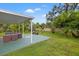 Spacious outdoor patio with seating, lush palm trees, and a well-maintained lawn at 1084 39Th Ne Ave, St Petersburg, FL 33703