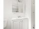 Bright bathroom with white cabinets, a large mirror, and a walk-in shower at 1084 39Th Ne Ave, St Petersburg, FL 33703
