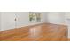 Bright living room featuring hardwood floors, a large window, and neutral wall paint at 1084 39Th Ne Ave, St Petersburg, FL 33703